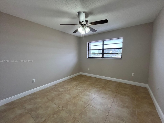 tiled empty room with a textured ceiling and ceiling fan