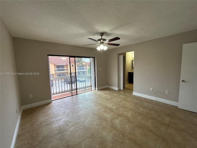 empty room featuring ceiling fan, a textured ceiling, and light tile patterned flooring