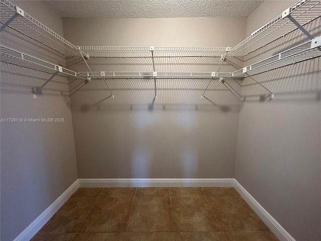 spacious closet featuring tile patterned flooring