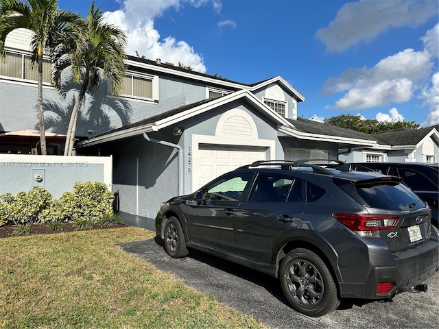 view of home's exterior featuring a lawn and a garage