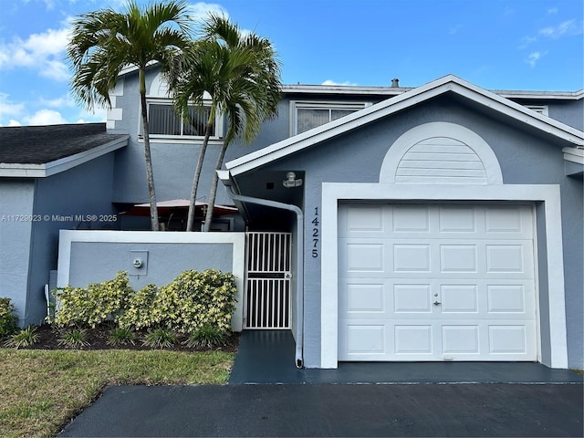 view of front of home with a garage and stucco siding