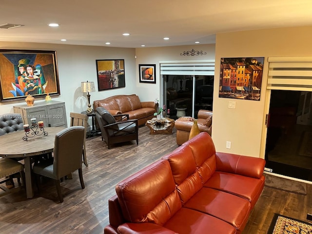 living area with wood finished floors, visible vents, and recessed lighting