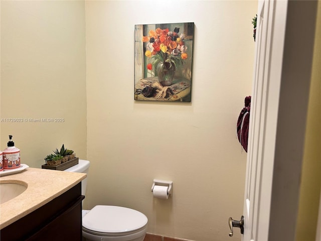 half bathroom with toilet and vanity