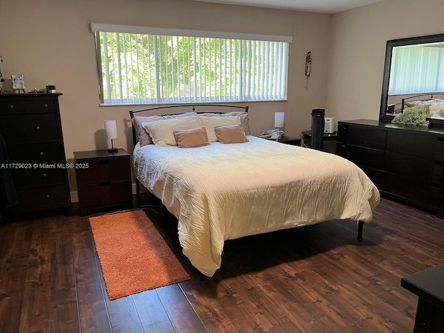 bedroom with dark hardwood / wood-style floors