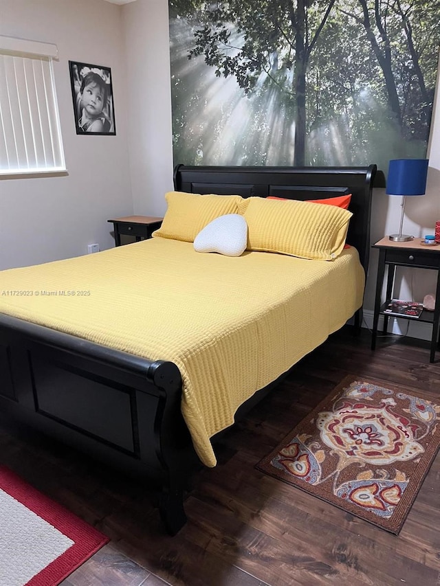 bedroom with dark wood-type flooring