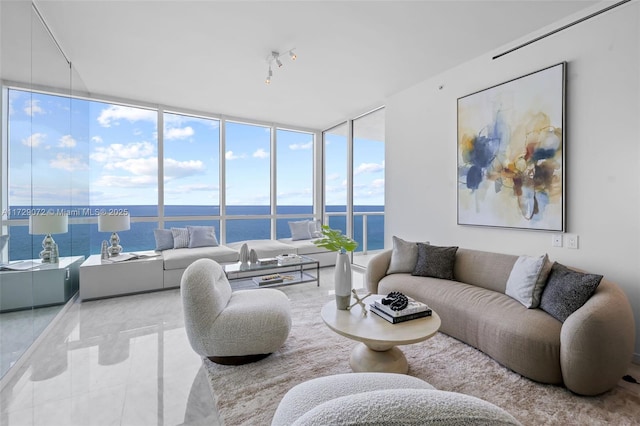 living room featuring a water view and floor to ceiling windows