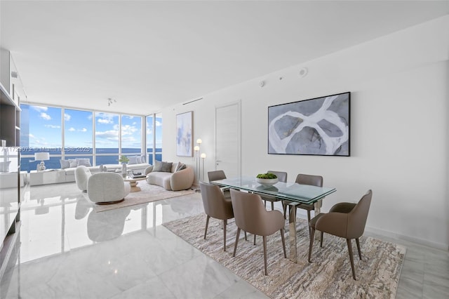 dining room with a wall of windows and a water view