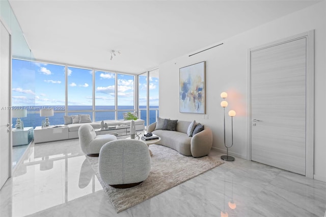 living room with floor to ceiling windows and a water view