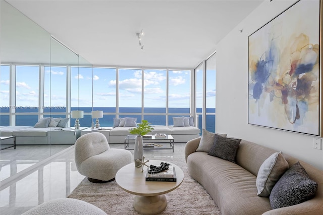 living room featuring a water view and a wall of windows