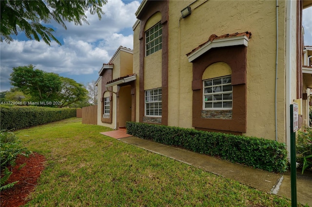 view of property exterior with a yard