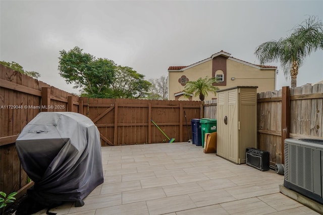 view of patio / terrace featuring a grill and central air condition unit