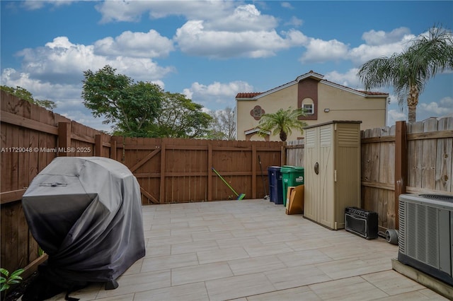 view of patio with cooling unit and a grill