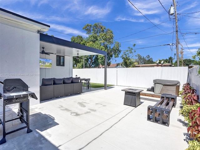 view of patio featuring an outdoor living space with a fire pit, grilling area, a hot tub, and ceiling fan