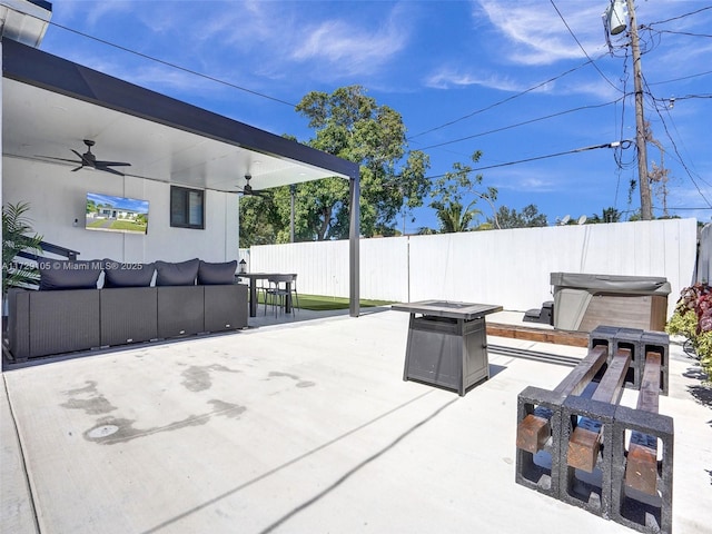 view of patio featuring ceiling fan, a hot tub, and an outdoor hangout area