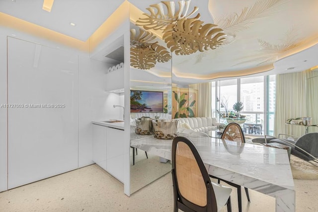 dining space with floor to ceiling windows and sink