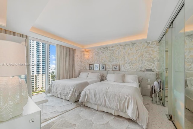 bedroom with a closet and a raised ceiling