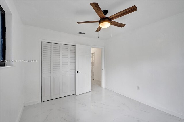 unfurnished bedroom with a closet and ceiling fan