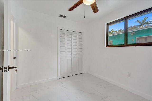 unfurnished bedroom with a closet and ceiling fan