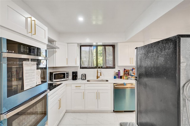 kitchen featuring white cabinetry, appliances with stainless steel finishes, and sink