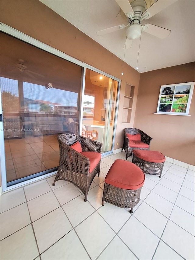 living room featuring ceiling fan and light tile patterned floors