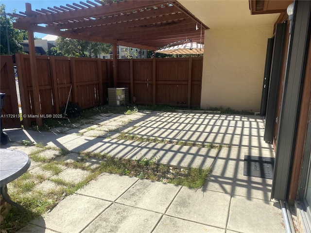 view of patio with cooling unit and a pergola