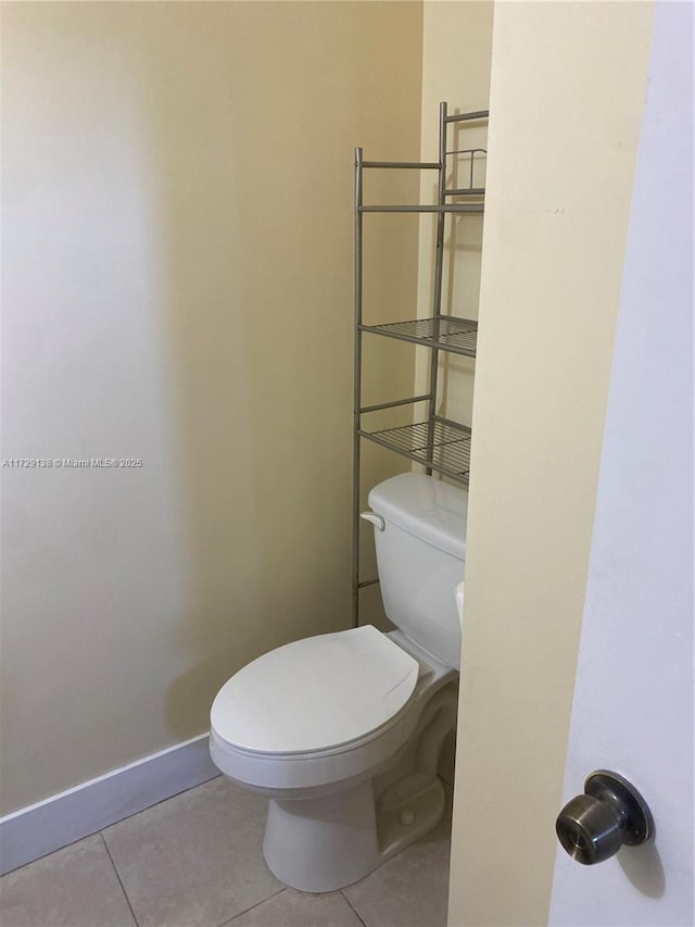 bathroom featuring tile patterned flooring and toilet