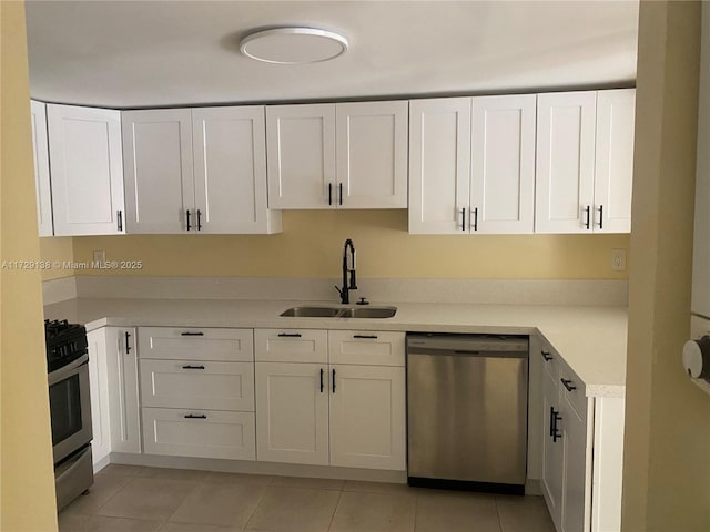 kitchen with white cabinetry, light tile patterned floors, sink, and appliances with stainless steel finishes