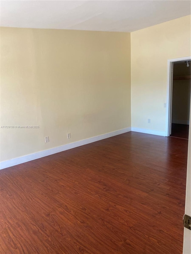 empty room featuring dark hardwood / wood-style flooring