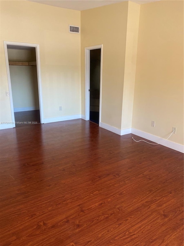 unfurnished room featuring dark hardwood / wood-style flooring