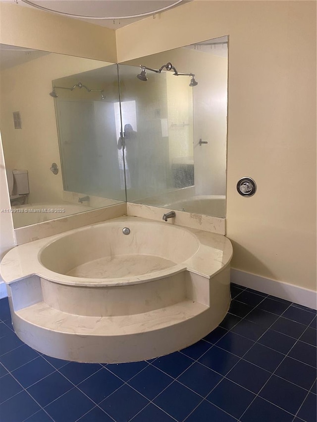 bathroom with tile patterned flooring and a tub