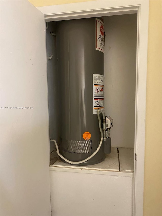 utility room featuring water heater