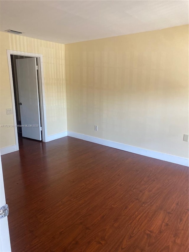 empty room with dark wood-type flooring