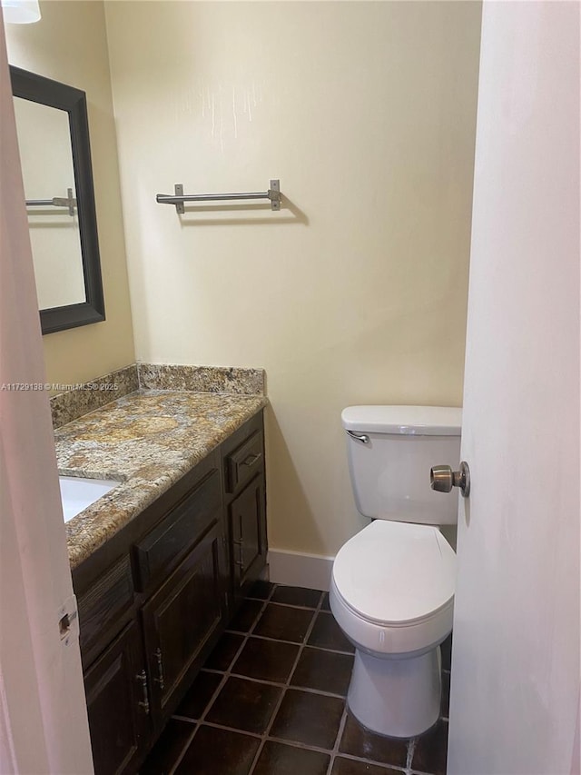 bathroom with vanity, tile patterned flooring, and toilet