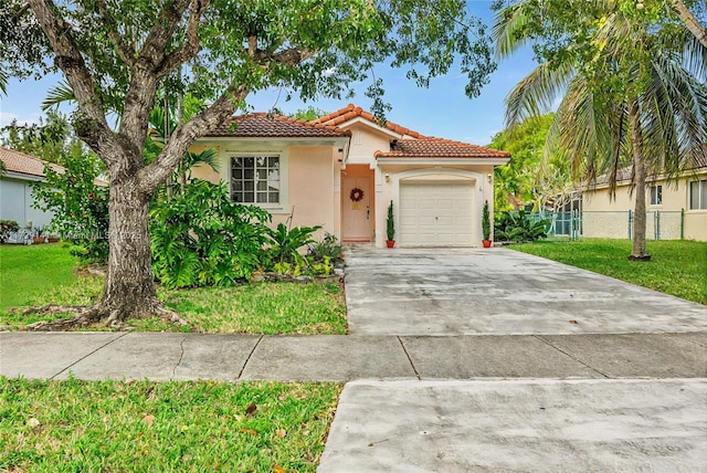 view of front of home featuring a garage and a front lawn