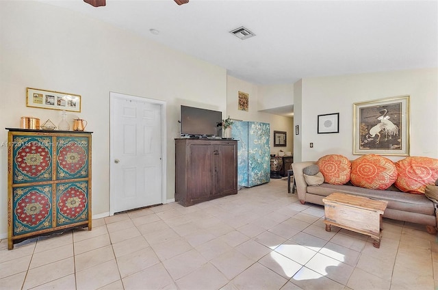 tiled living room with ceiling fan and vaulted ceiling