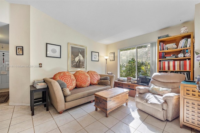 living room featuring vaulted ceiling and light tile patterned floors