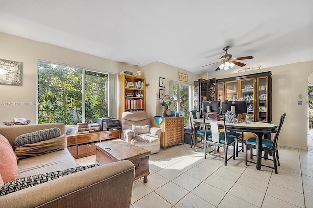 living room with ceiling fan, light tile patterned floors, and plenty of natural light