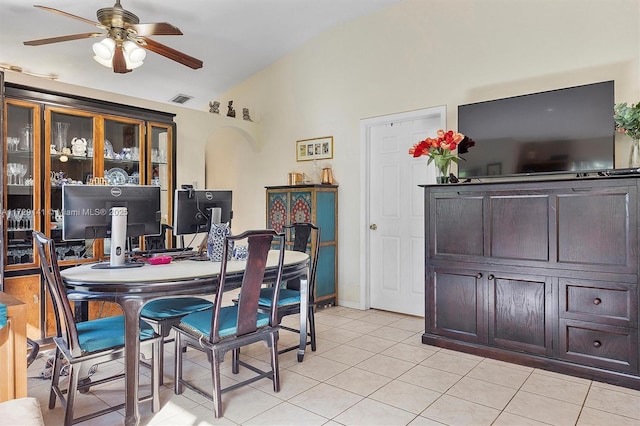 dining area featuring vaulted ceiling, ceiling fan, and light tile patterned floors