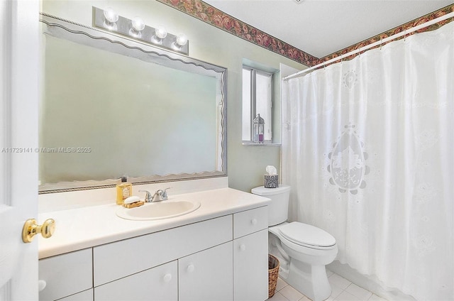 bathroom with tile patterned floors, toilet, vanity, and walk in shower