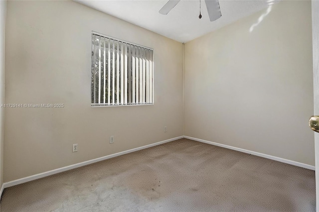 empty room featuring carpet floors and ceiling fan