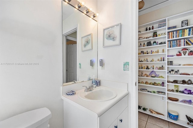 bathroom featuring toilet, vanity, and tile patterned flooring