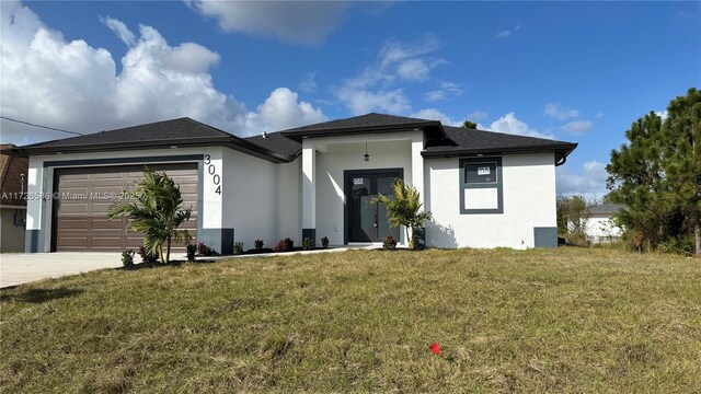 view of front of property with a garage and a front yard