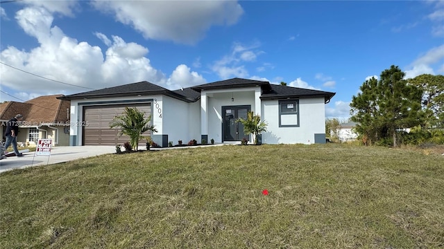 view of front of property featuring a garage and a front lawn