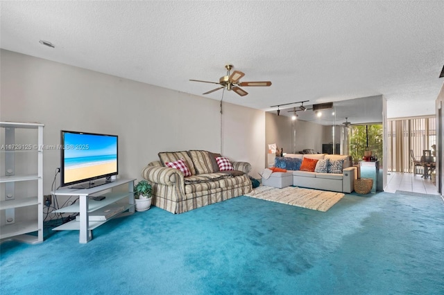 living room featuring floor to ceiling windows, ceiling fan, carpet, track lighting, and a textured ceiling