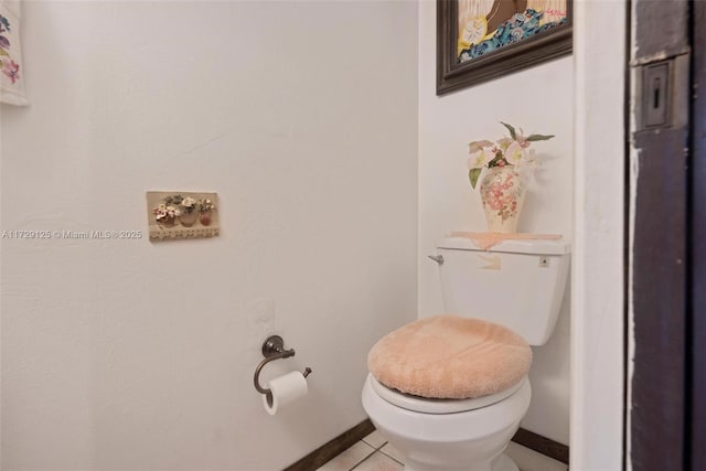 bathroom with toilet and tile patterned flooring