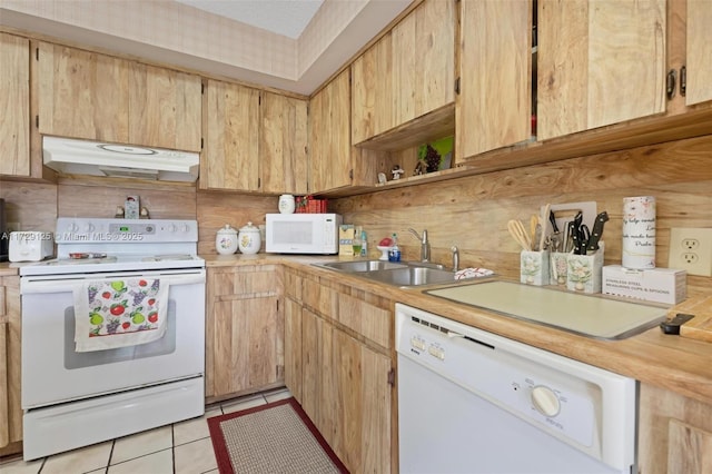 kitchen featuring light brown cabinetry, light tile patterned floors, sink, and white appliances