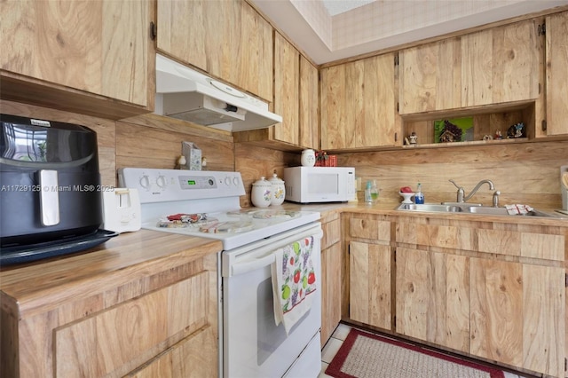 kitchen featuring light brown cabinets, butcher block counters, sink, and white appliances