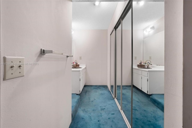 bathroom featuring a textured ceiling and vanity