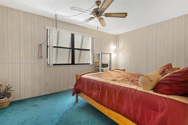 carpeted bedroom featuring a textured ceiling and ceiling fan