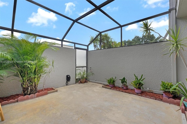 view of patio featuring glass enclosure